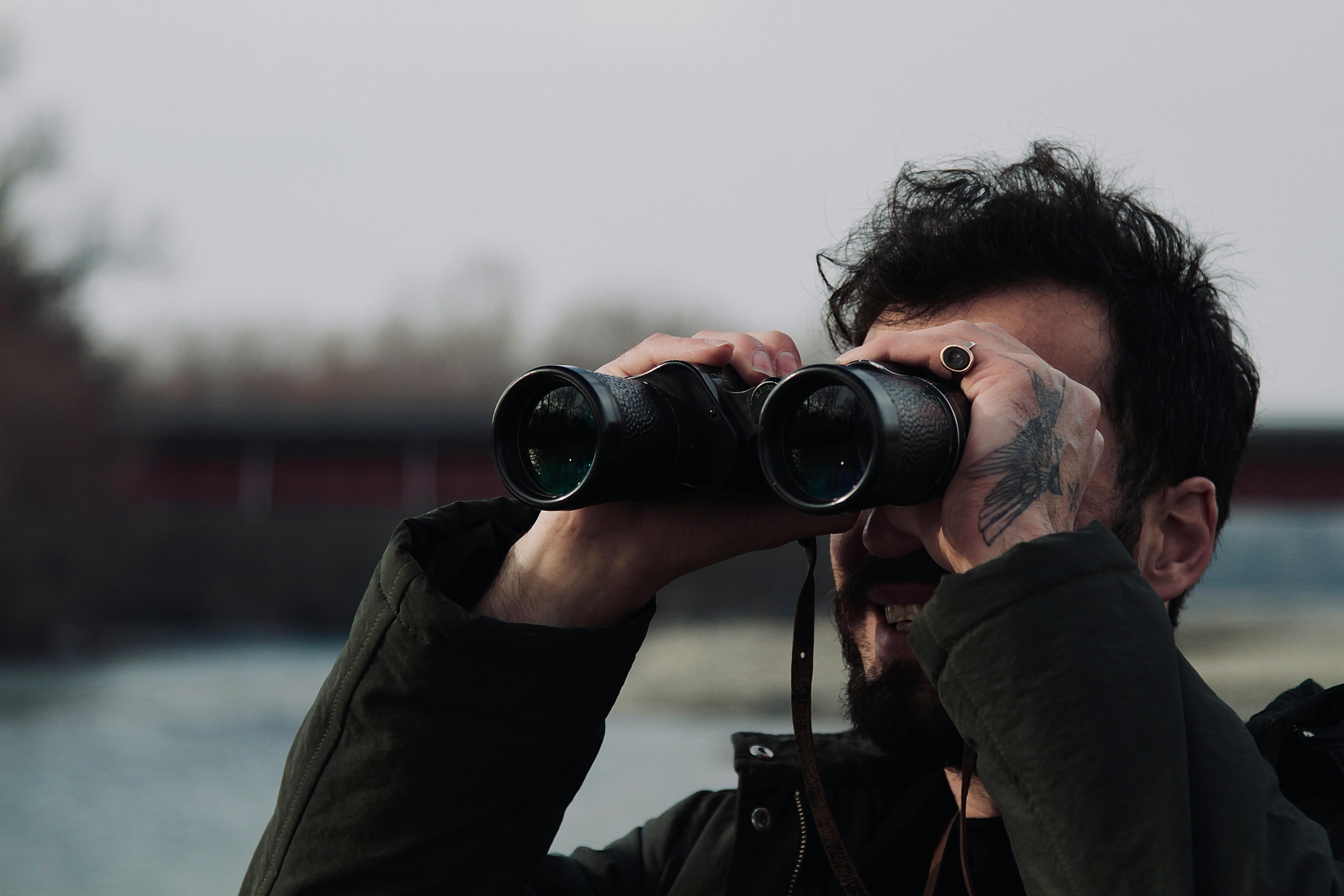 Man looking through binoculars